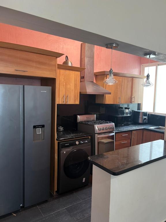 a kitchen with a stove and a refrigerator at Dreamvillage in Boca Chica