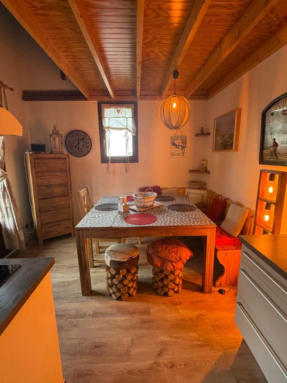 Un comedor con una mesa y una habitación con un sofá. en beau duplex marmotiere, en Risoul