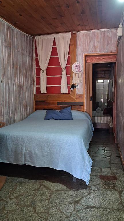 a bedroom with a large bed and a window at Depto III in Capilla del Monte