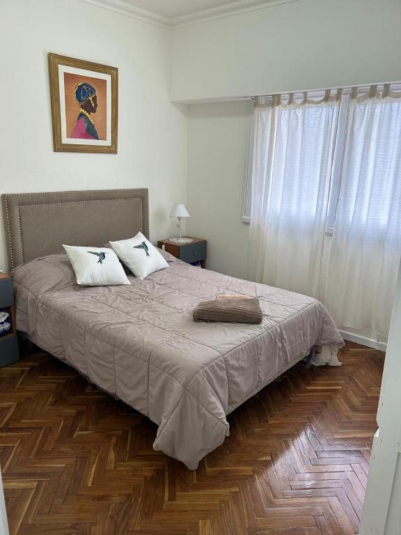 a bedroom with a bed with two pillows on it at Pasala Lindo in Tandil