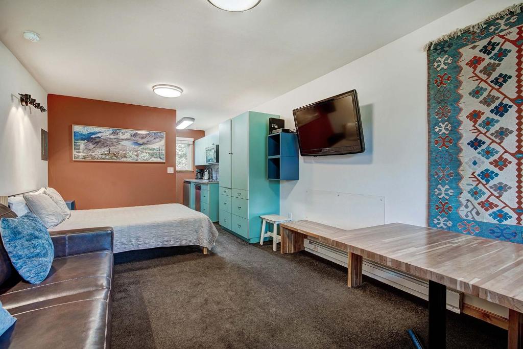 a room with a bed and a tv and a couch at Park Meadows 7D by Ski Country Resorts in Breckenridge