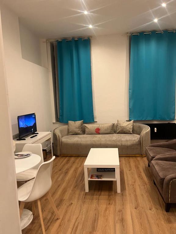a living room with a couch and a table at The central stay in Mellet