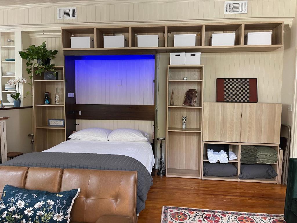 a bedroom with a bed and a couch in a room at Romantic Studio Apt in Historic Downtown Savannah in Savannah