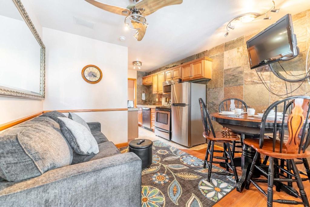 a living room with a couch and a table at Park Meadows 6A by Ski Country Resorts in Breckenridge
