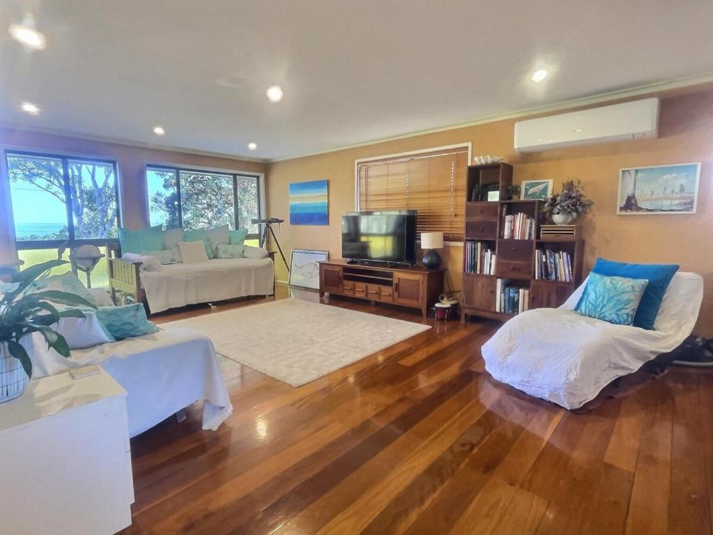 a living room with a couch and a tv at Vista at Straddie View in Dunwich