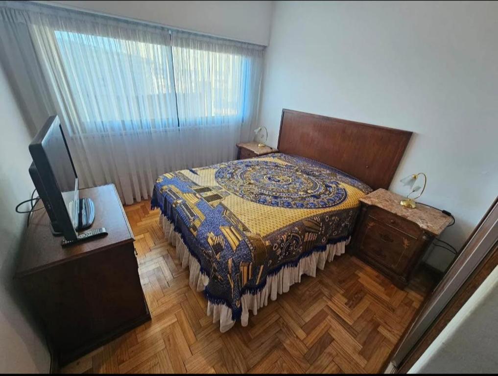 a bedroom with a bed and a television in it at Depto para 6 personas playa grande con seña in Mar del Plata