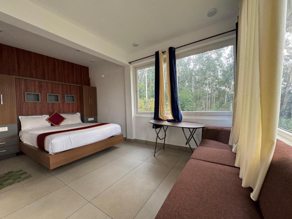 a bedroom with a bed and a large window at Honeyrock Farm Resort by Skybz in Kanthalloor