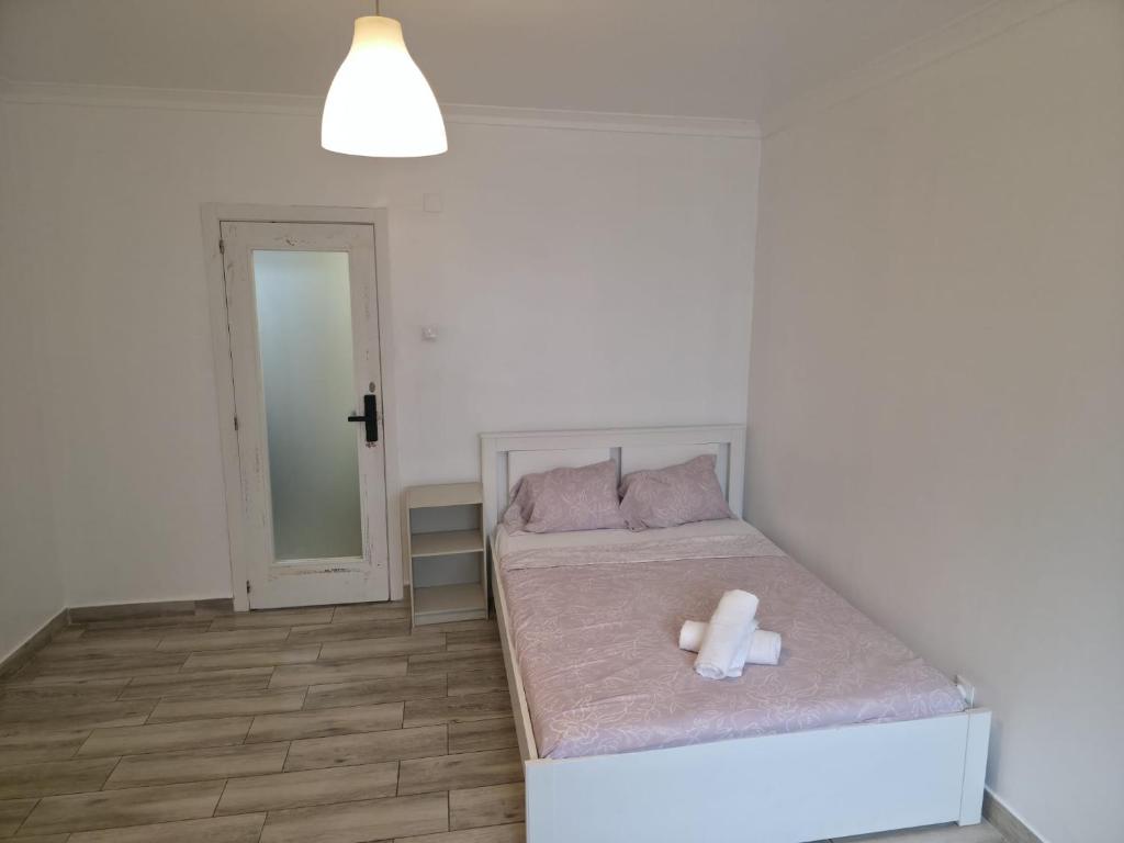a bedroom with a bed with a stuffed animal on it at Nok Nok in Odivelas