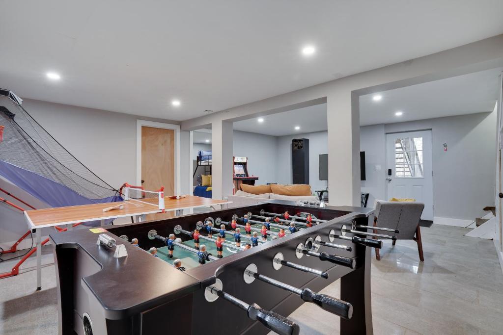 a room with a foosball table and a couch at 3bd 2ba hot tub, game room, bunk beds in Long Pond