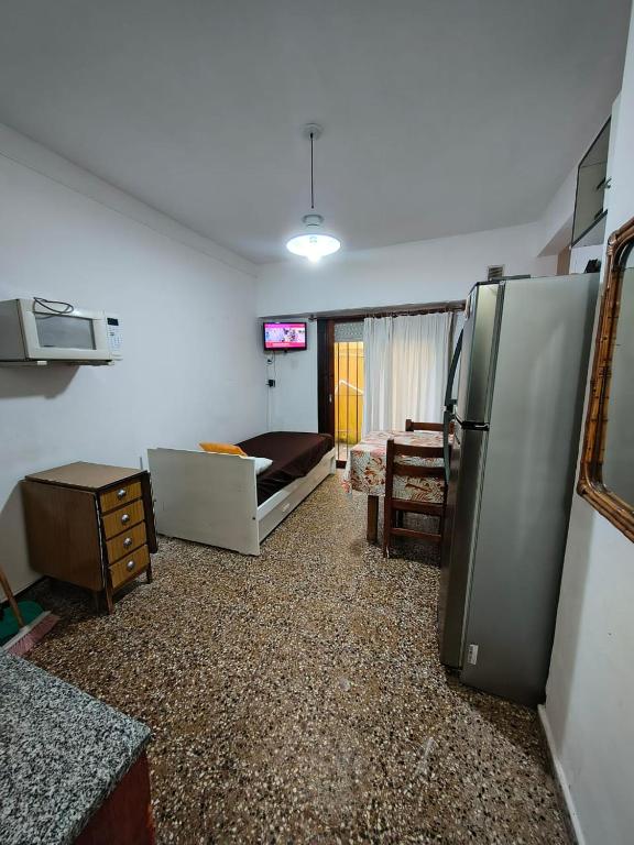 サンベルナルドにあるDepto 2 amb San Bernardoのリビングルーム(冷蔵庫付)、ベッドルーム1室が備わります。