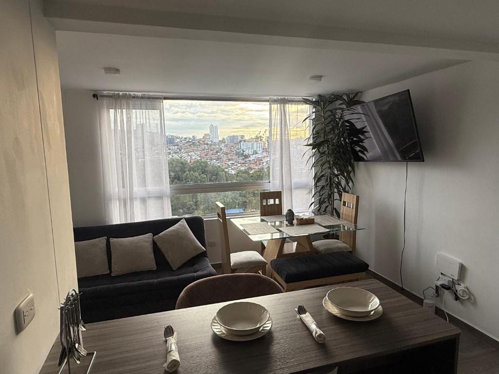 a living room with a couch and a table at Simplemente en Casa! in Manizales