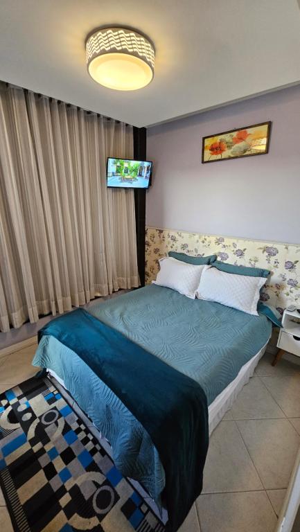 Ένα ή περισσότερα κρεβάτια σε δωμάτιο στο Suite Grande Rio - Ar condicionado