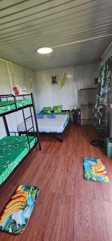 a room with two bunk beds and wooden floors at Banana Bar in San Juan