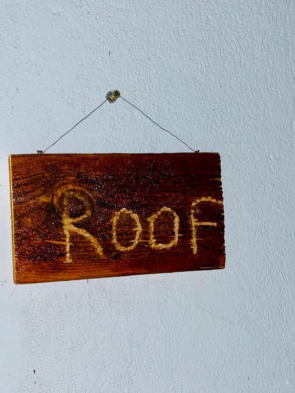 a wooden sign with the word root hanging on a wall at Luxor in Luxor