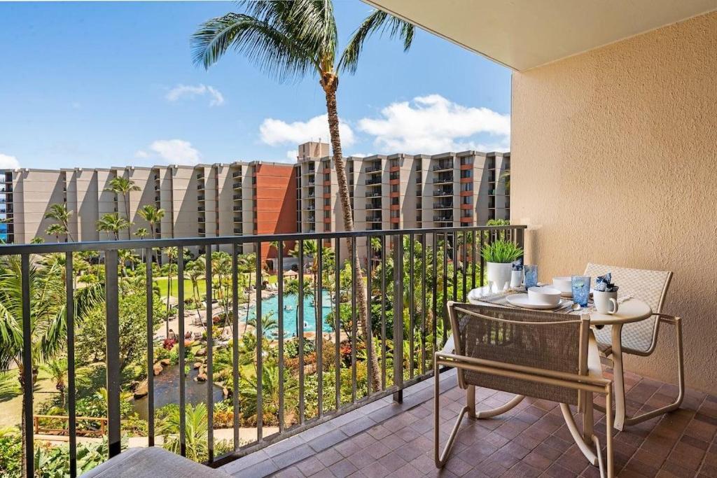 a balcony with a table and a view of a building at Kaanapali Shores 548 in Kahana