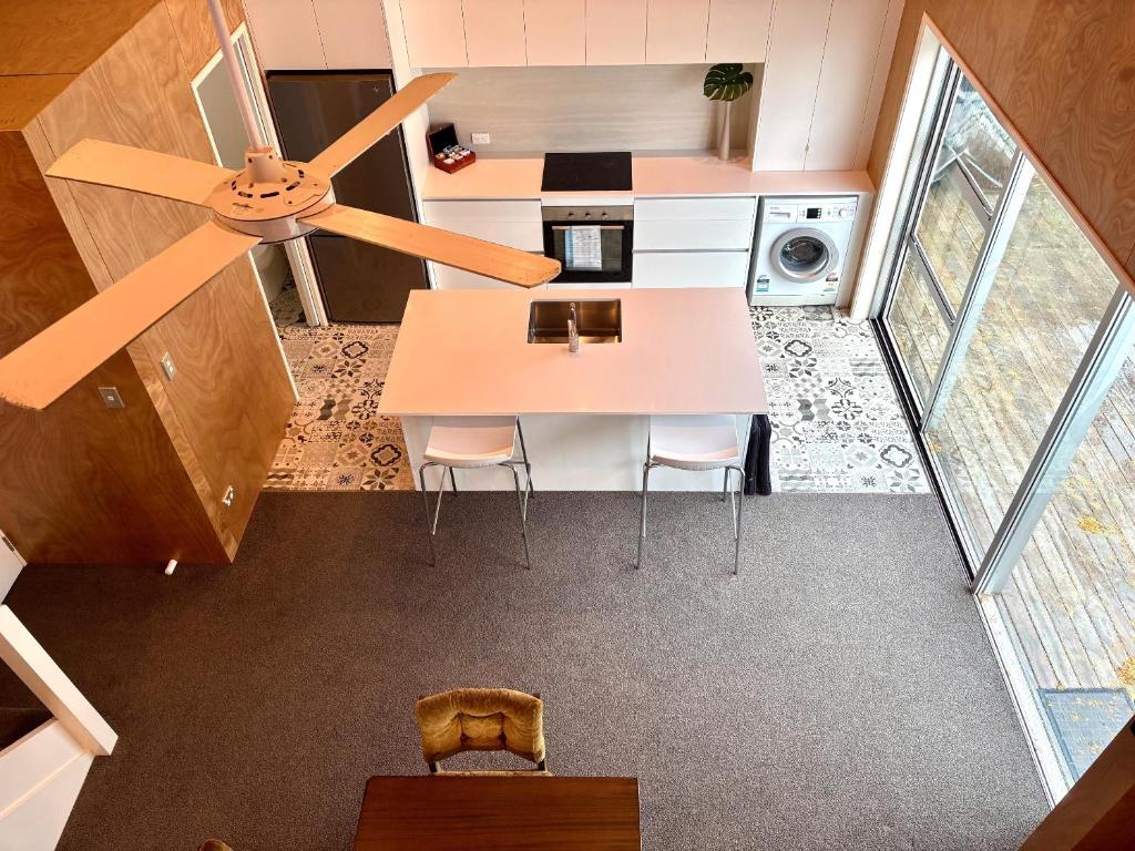 an overhead view of a kitchen with a ceiling fan at The Black Shed Studio in New Plymouth