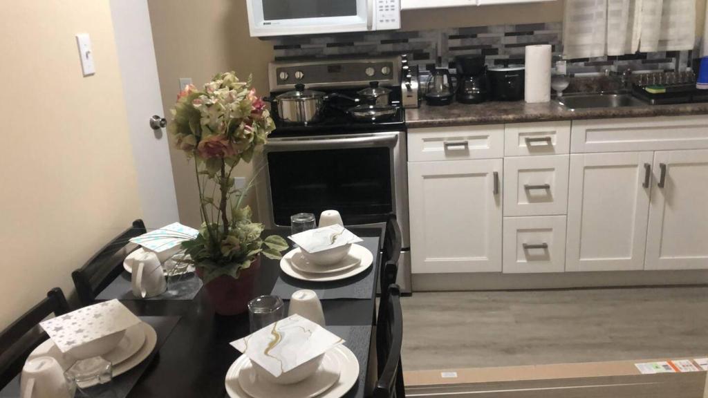 a kitchen with a table with white dishes on it at 347 Des Meurons Street Unit A and Unit B in Bélanger