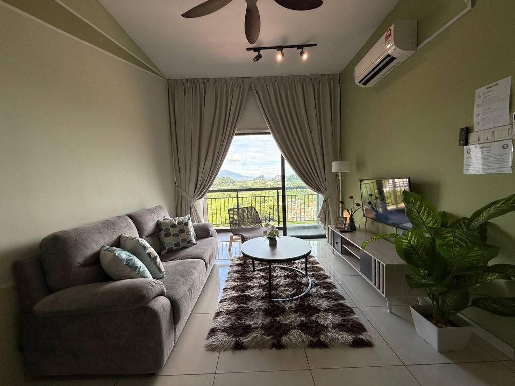 a living room with a couch and a table at The Horizon Ipoh Stay by Grab A Stay in Ipoh