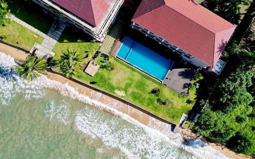 an aerial view of a house next to the ocean at Baga Resort Hotel in Lagudri