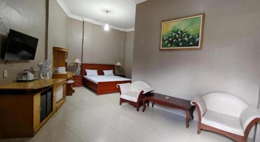 a living room with a couch and a tv at Sapadia Hotel Parapat in Parapat