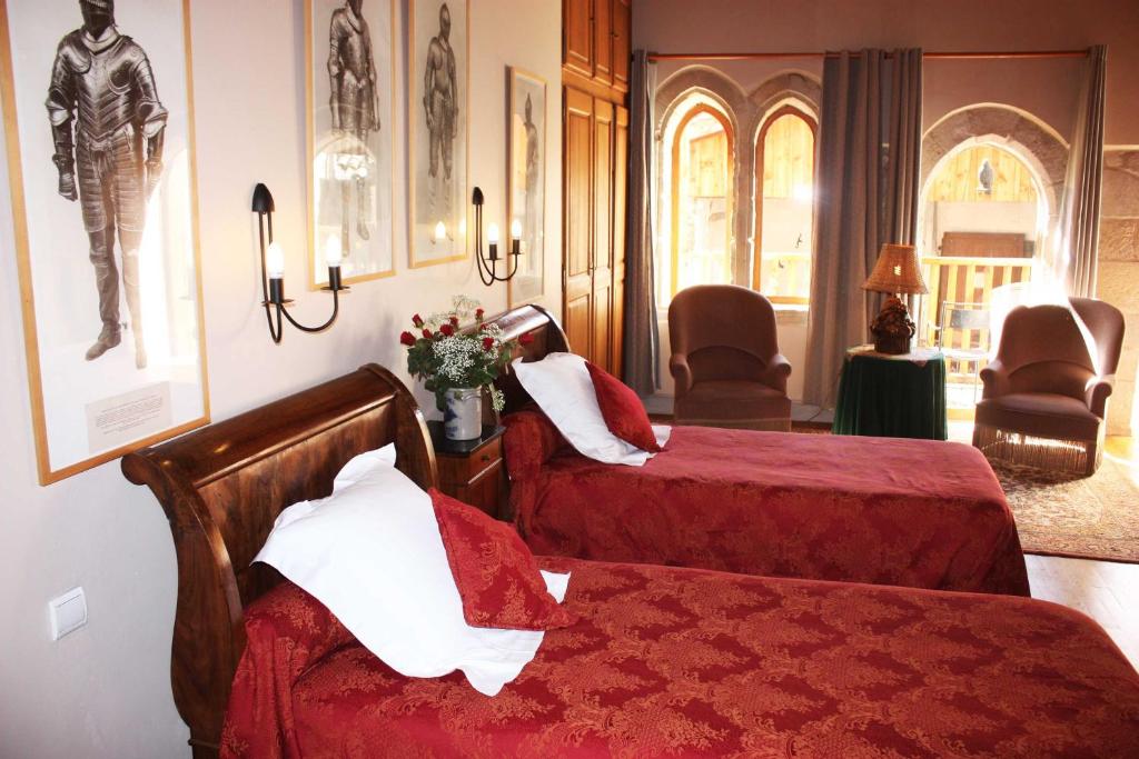 une chambre d'hôtel avec deux lits et deux chaises dans l'établissement L'Ancienne Auberge, à Puycelci