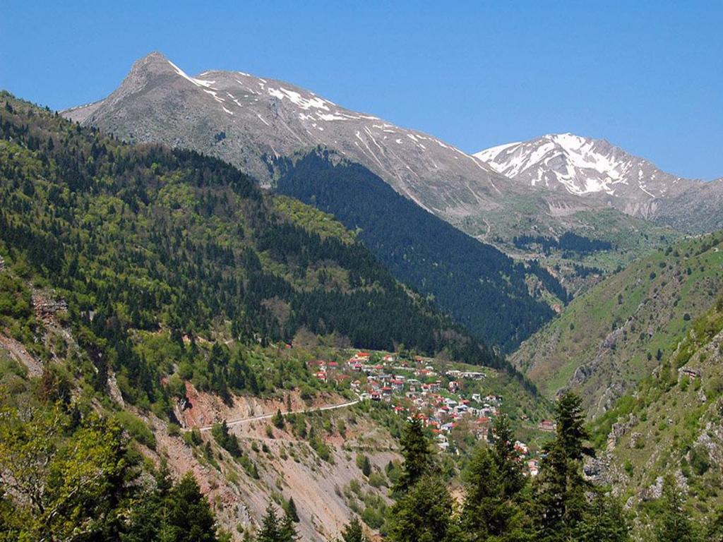 a mountain with a town in the middle of a valley at Family Country House in Agía Paraskeví