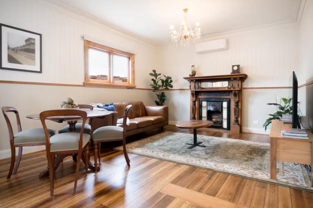 a living room with a couch and a table at 2 Houses, 1 Booking, Great Location in Launceston
