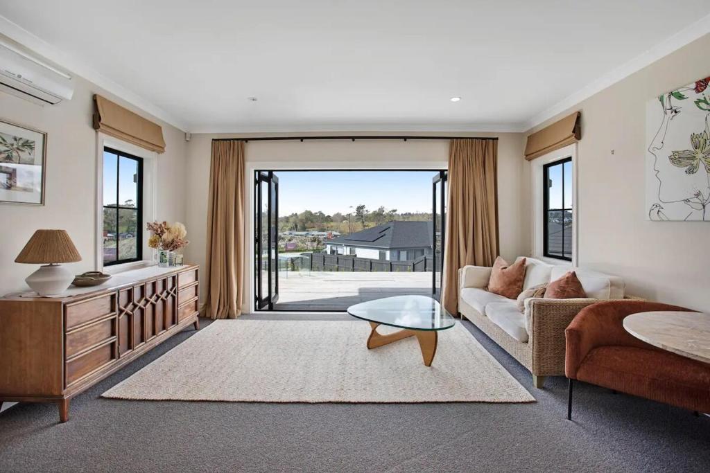 a living room with a couch and a table at Luxury Mansion 7bdrm 6bth pool pizza ovn 25mns CBD in Silverdale