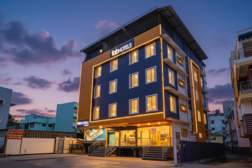 a building with a hotel sign on it at FabHotel VJR Electronic City in Bengaluru