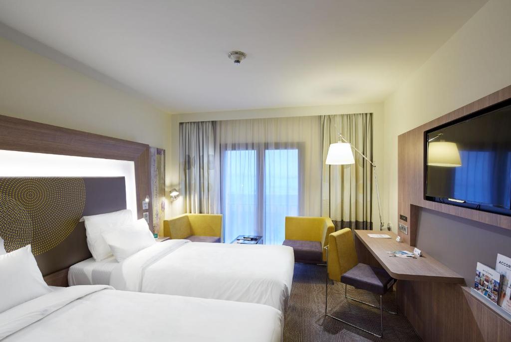 Cama ou camas em um quarto em Novotel Diyarbakir