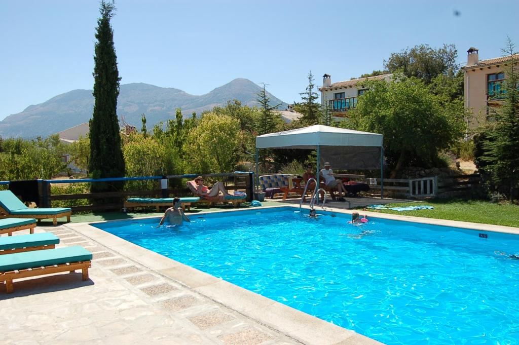 a swimming pool with people playing in the water at Cabañas Imagina in Torres