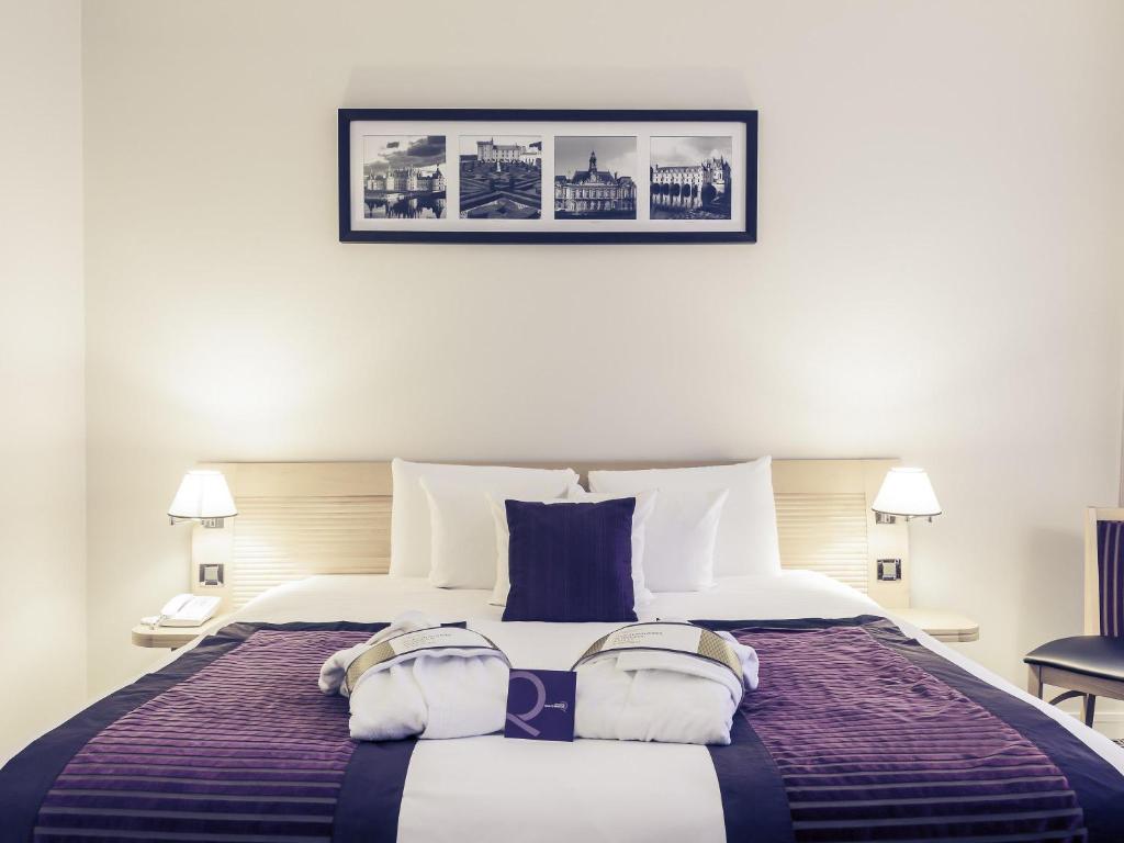 a bedroom with a large bed with two pillows at Mercure Tours Centre Gare et Congrès in Tours