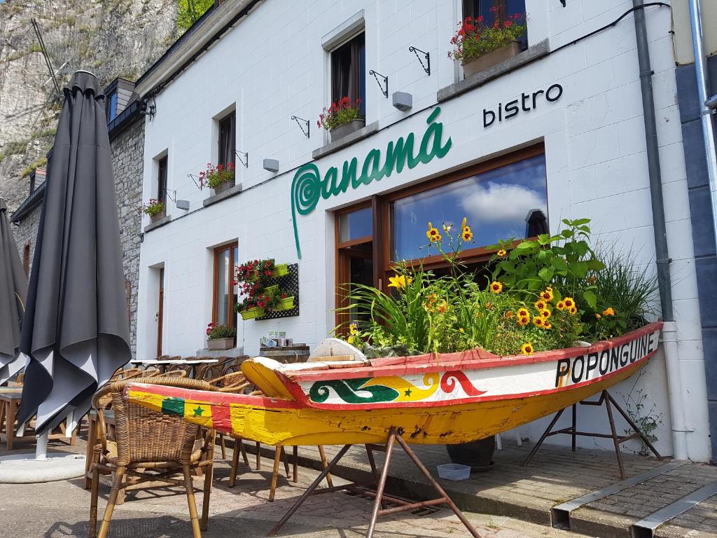 a boat on display in front of a restaurant at Panamá in Dinant