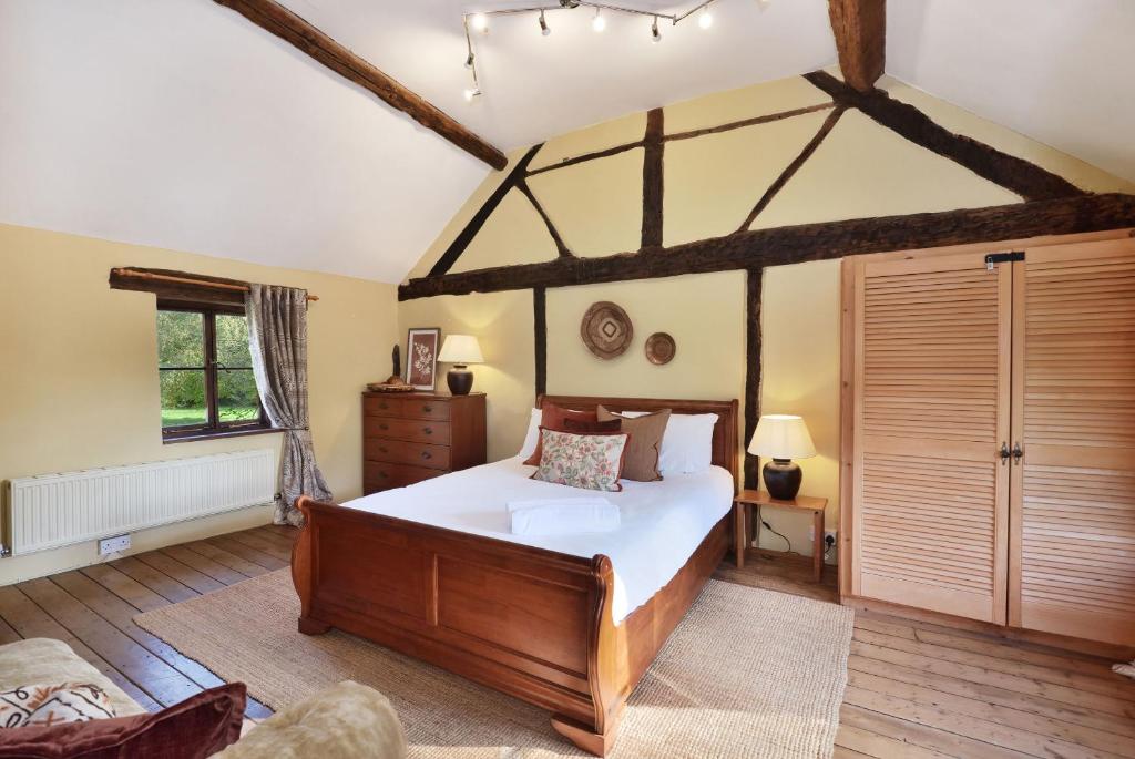 a bedroom with a large bed in a room at Historic Farmhouse Idyllic Pets Nr Bromyard in Pencombe