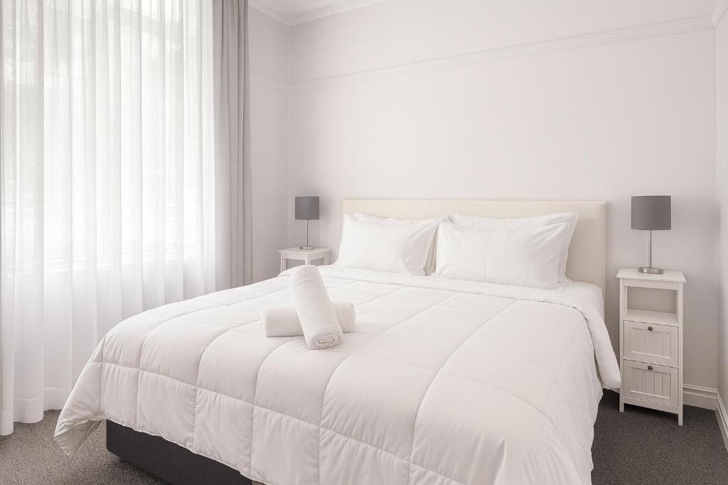 Ένα ή περισσότερα κρεβάτια σε δωμάτιο στο Anzac Executive Apartments Brisbane