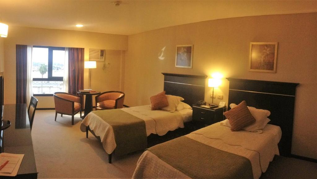 Säng eller sängar i ett rum på Condado Hotel Casino Goya