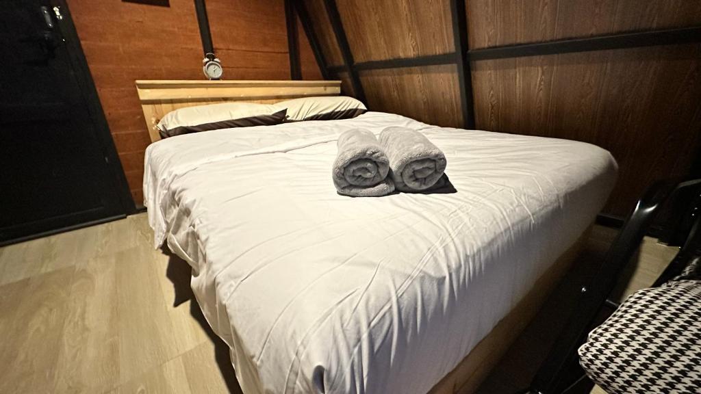 a bed with two donuts on top of it at Akimebonphuresort in Ban San Pu Loei (2)