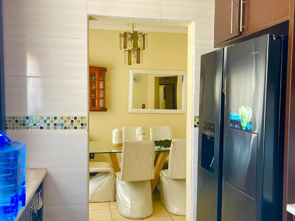 a kitchen with a table and a refrigerator at Inocova Fly in Kempton Park