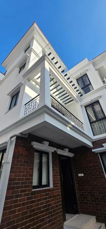 a white building with a balcony on top of it at Samaya Private Home Panipokhari - 5BHK in Thapathali