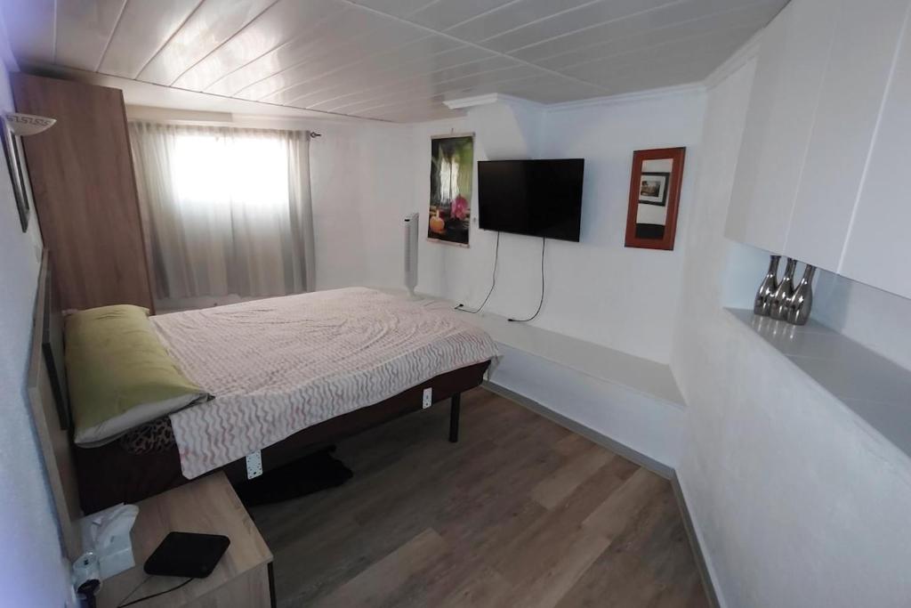a small bedroom with a bed and a television at Peaceful Holiday Home with a Touch of Comfort in San Miguel de Salinas