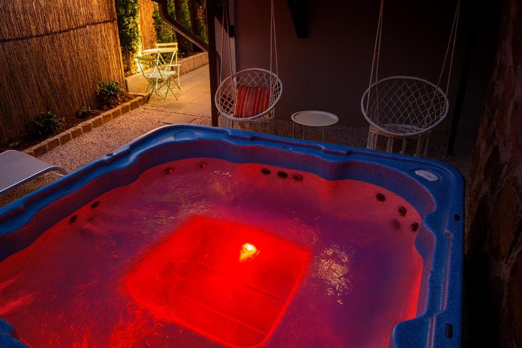 a jacuzzi tub with a red light in it at Gîte pour 14 personnes avec jacuzzi proche de Kaysersberg et Colmar in Lapoutroie