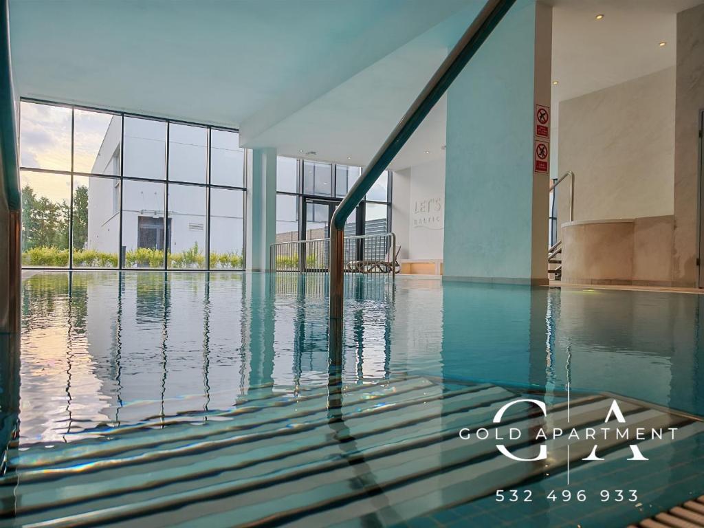 a view of the swimming pool of a building at Gold Apartment E54 Let's Sea Baltic Park Gąski in Gąski
