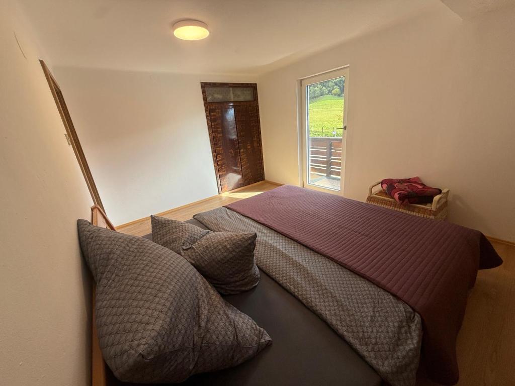 a bedroom with a large bed and a window at Villa Helga Am Steinernem Meer in Saalfelden am Steinernen Meer