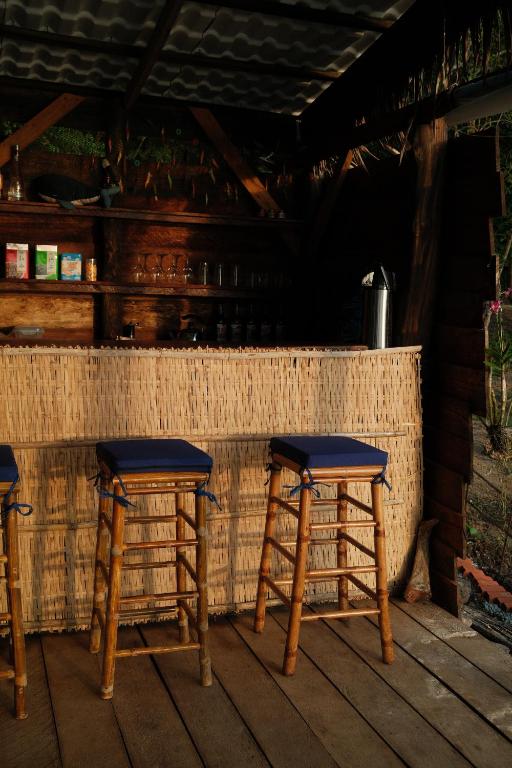 a pair of wooden stools sitting on a porch at Bubble Paradise, Koh ta Kiev in Koh Ta kiev Island