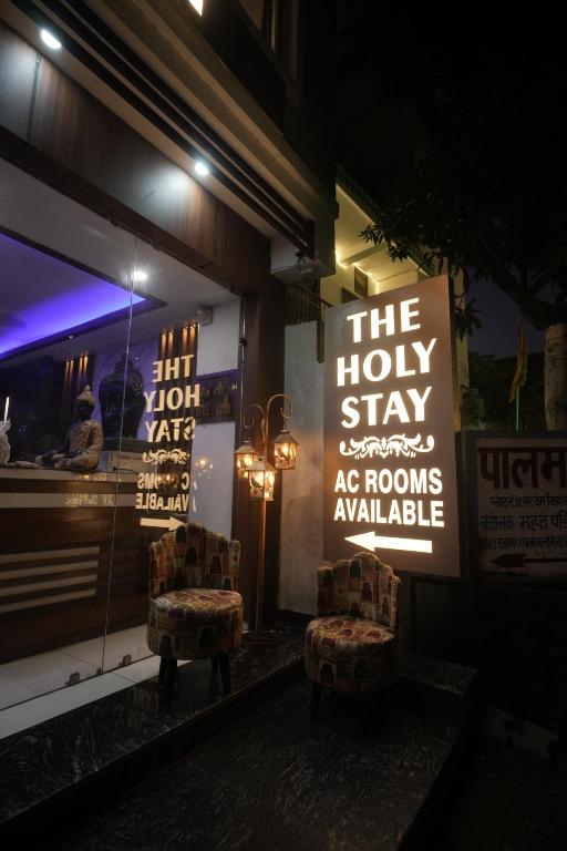 a store front with two chairs in front of a window at The Holy Stay in Haridwār