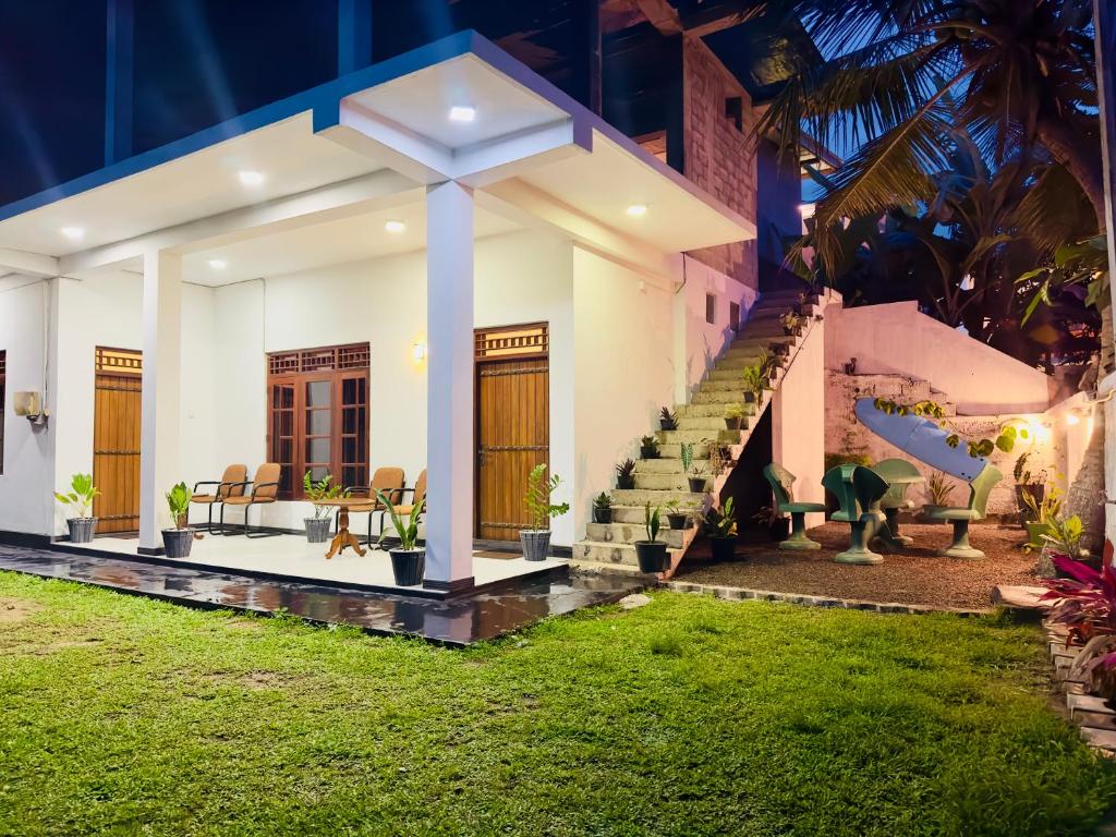 a house with a lawn in front of it at Abheena - Weligama in Weligama
