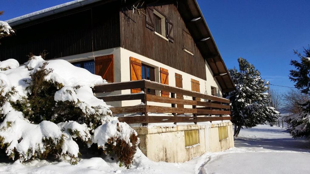 a house covered in snow in front at Chalet Mouthe 6 personnes in Mouthe