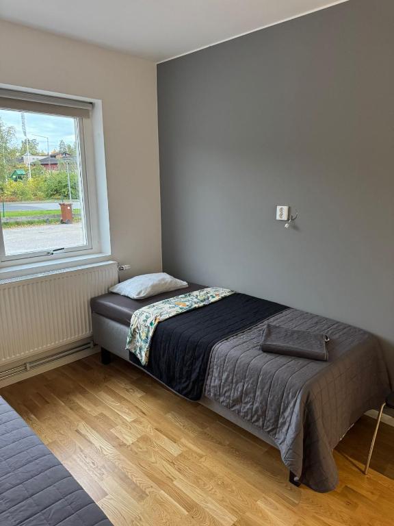 a bedroom with a bed and a window at Apartment 17 in Sollentuna in Sollentuna
