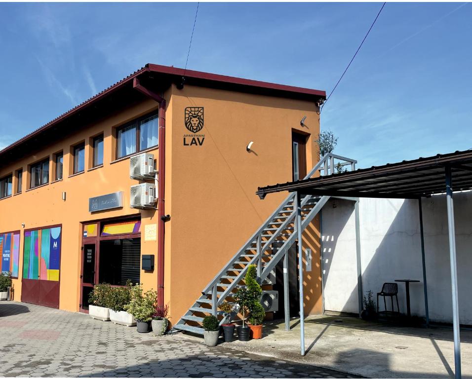 a building with a staircase in front of it at LAV apartmani in Karlovac