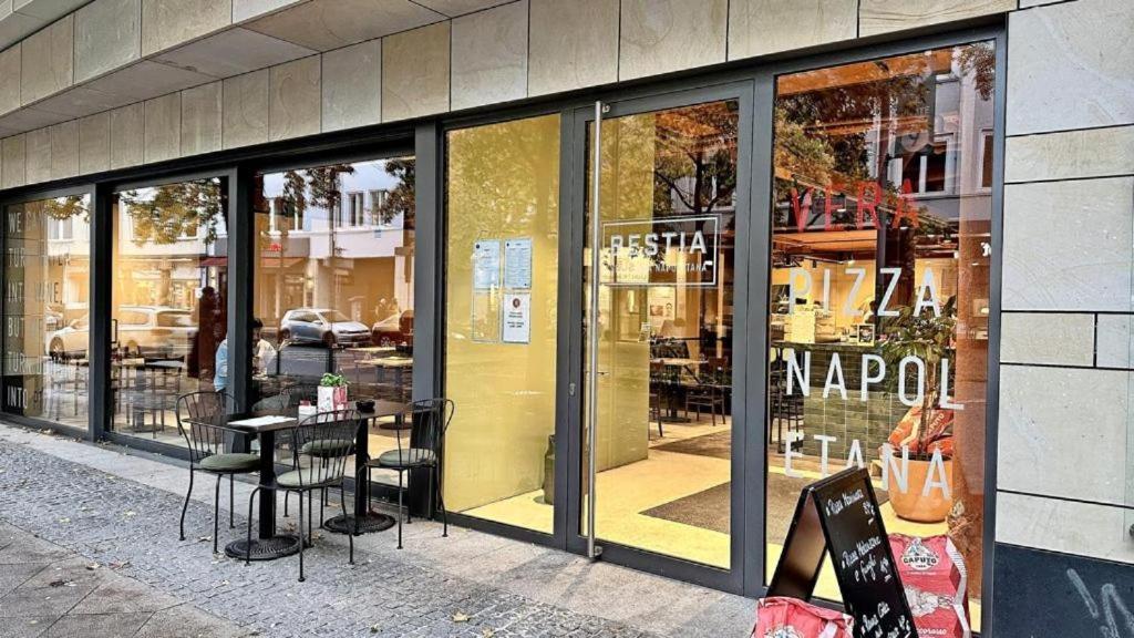a store window with a table and chairs in front of it at Residence Amira in Hannover